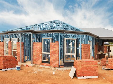 metal framework around a house being renovated|metal framing for residential homes.